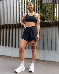 Woman wearing Accelerate 3" High-Rise Running Short - Black | Model:Beccie | Size:S