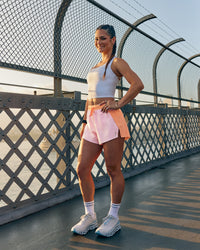 Woman wearing Accelerate 3" High-Rise Running Short - Cantaloupe-Marshmallow | Model:Jasynta | Size:S