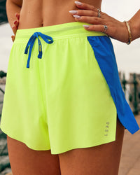 Woman wearing Accelerate 3" High-Rise Running Short - Electric Indigo-Lime Glo | Model:Jasynta | Size:S