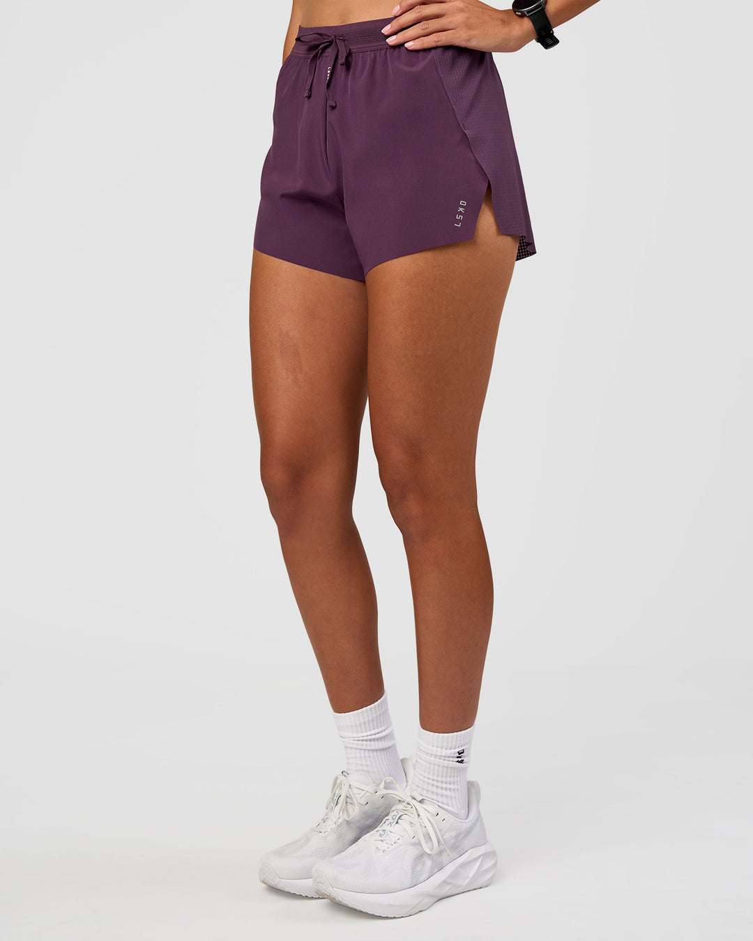 Woman wearing Accelerate 3" High-Rise Running Short - Midnight Plum | Set:true | Angle:side | Model:Rhiley | Size:S