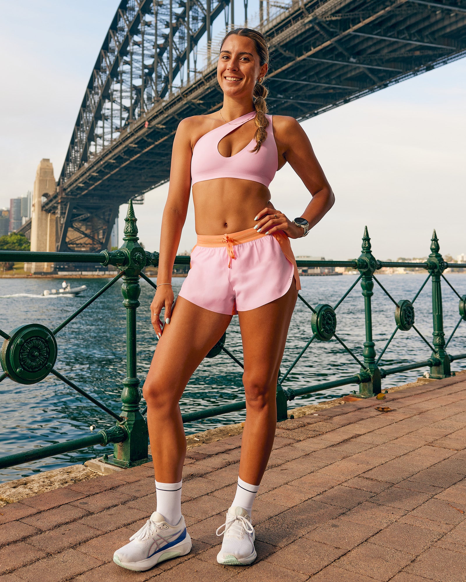 Woman wearing Accelerate 3" Mid-Rise Running Short - Cantaloupe-Marshmallow | Model:Olivia | Size:S