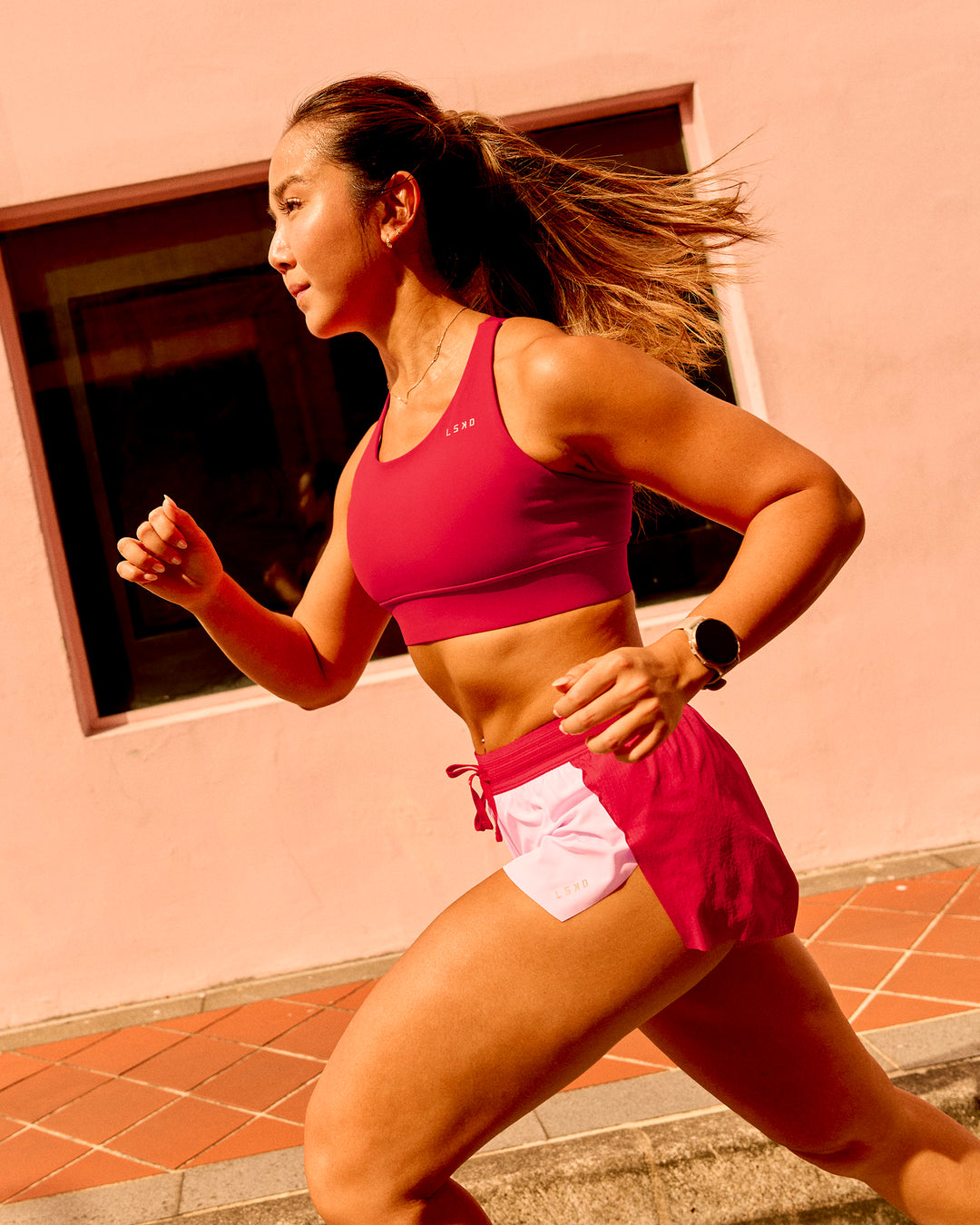 Woman wearing Accelerate 3" Mid-Rise Running Short - Scarlet-Marshmallow | Model:Clare | Size:S