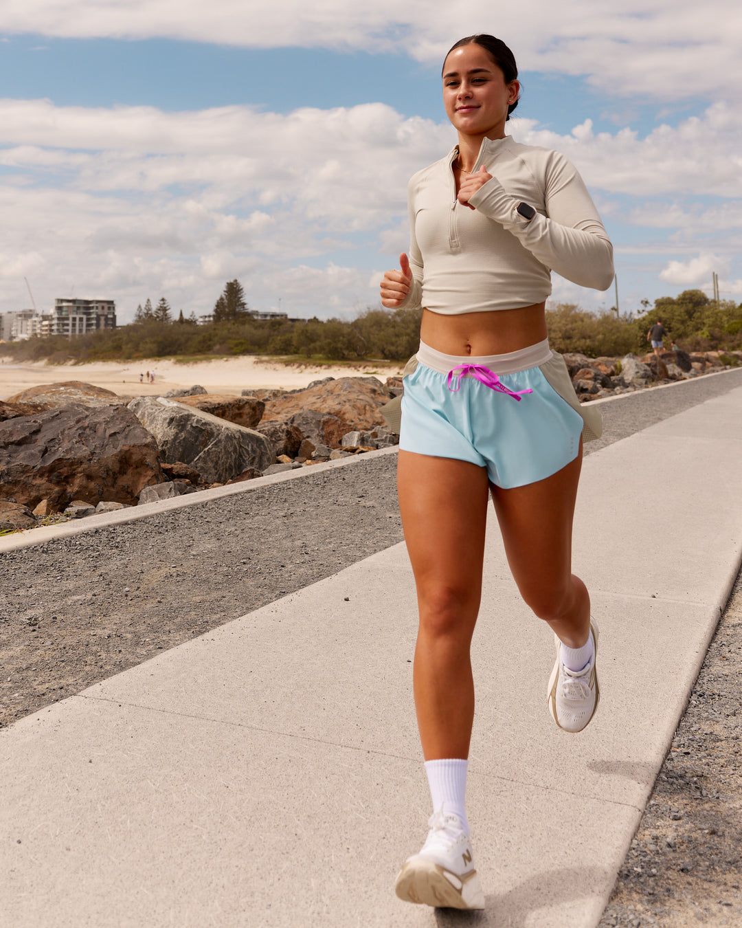Woman wearing Accelerate 3" Mid-Rise Running Short - Taupe Ash-Glacial Blue | Model:Kiara | Size:S
