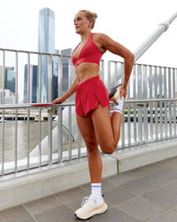 Woman wearing Accelerate Run Shorts - Scarlet | Model:Katie | Size:S