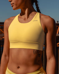 Woman wearing Accelerate Sports Bra - Lemon | Model:Vanessa | Size:S | Thumbnail Index: 2