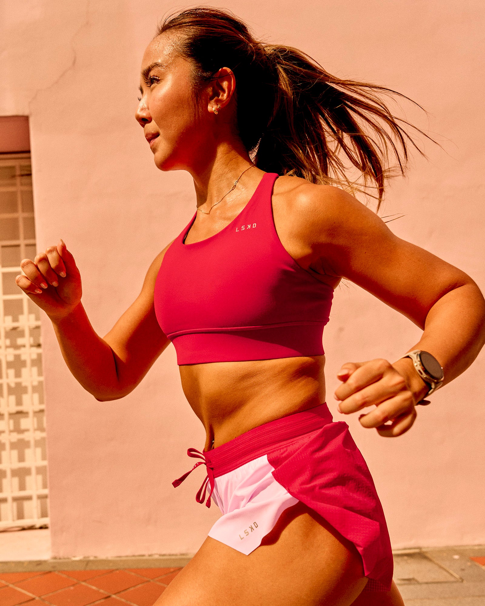 Woman wearing Accelerate Sports Bra - Scarlet | Model:Clare | Size:S