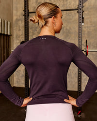 Woman wearing AeroFLX+ Seamless Long Sleeve Tee - Midnight Plum/Midnight Plum | Model:Charli | Size:XS