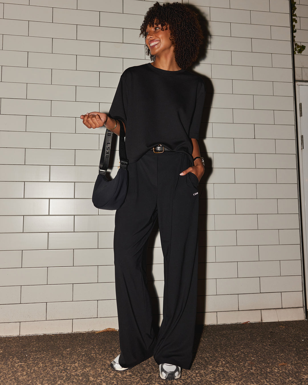 Woman wearing AfterDark ZeroCrease Cropped Tee - Black | Model:Tomi | Size:S