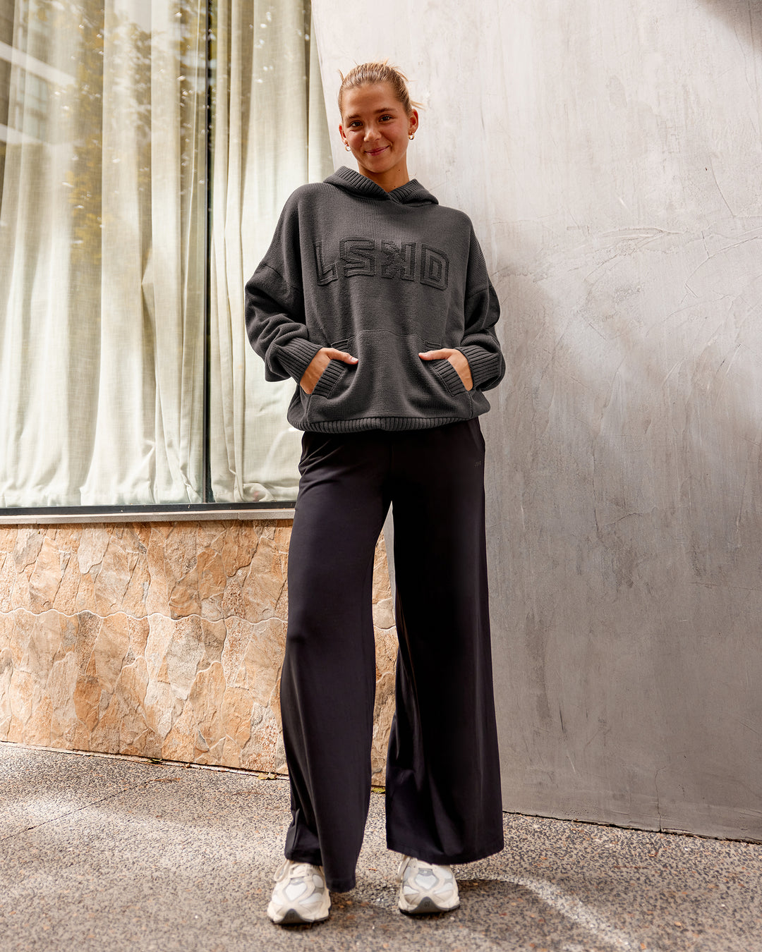 Woman wearing All Day Active Knitted Hoodie - Dark Storm | Size:S