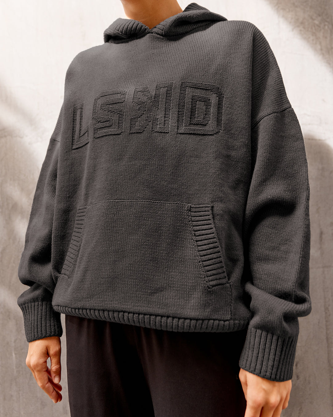 Woman wearing All Day Active Knitted Hoodie - Dark Storm | Size:S