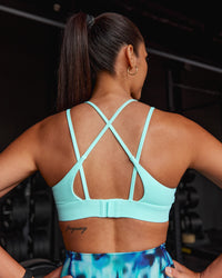 Woman wearing Aria Triangle Sports Bra - Island Paradise | Model:Rhiley | Size:S