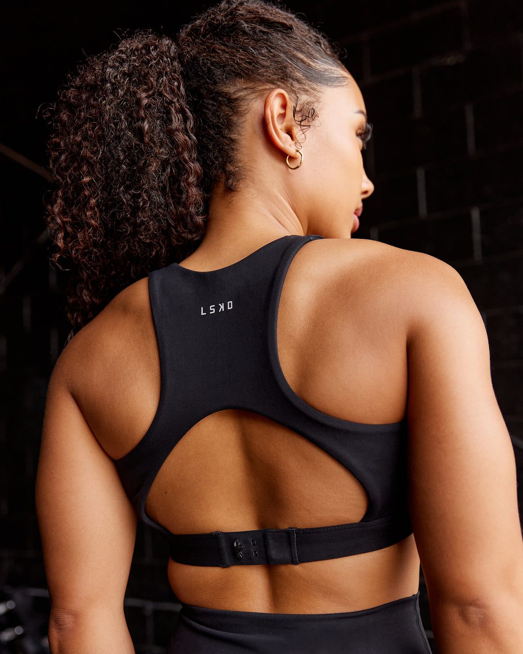 Woman wearing Ascent Sports Bra - Black | Model:Tarnie | Size:S