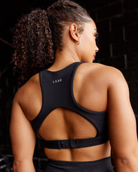Woman wearing Ascent Sports Bra - Black | Model:Tarnie | Size:S
