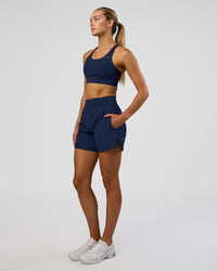 Woman wearing Challenger 5" Lined Performance Short - Future Navy | Model: Evie | Size:S