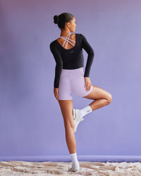 Woman wearing Effortless Long Sleeve Top - Black | Model:Tali | Size:S