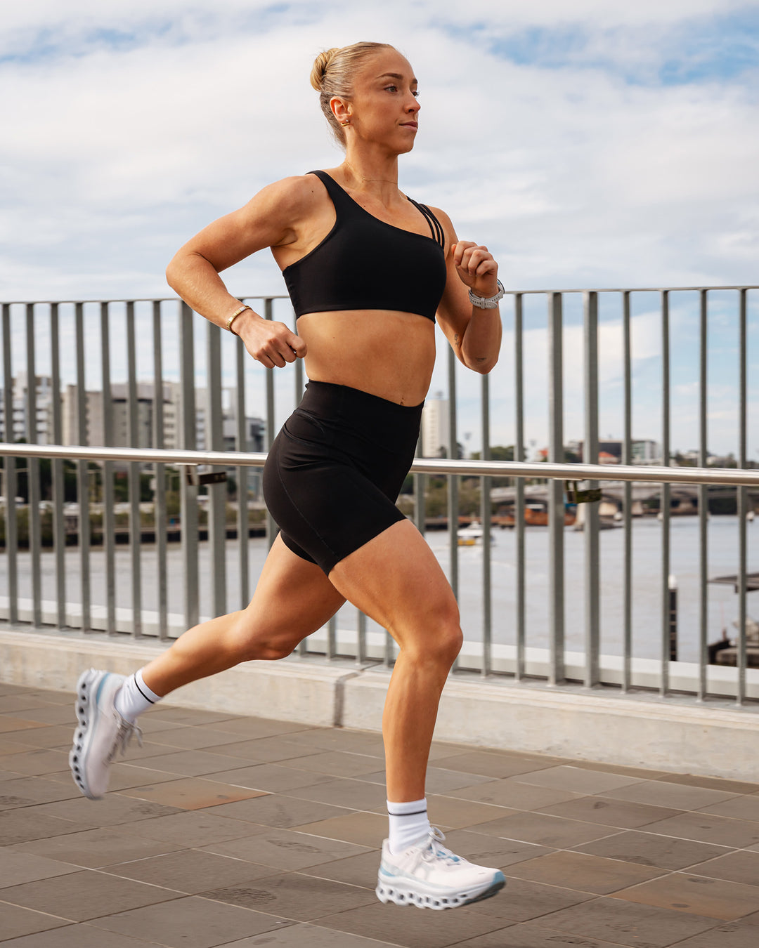 Woman wearing Elite Run High-Rise 7&quot; Short Pockets - Black | Model:Bronte | Size:S