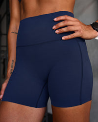Woman wearing Elixir Ultra High-Rise 4" Short Pockets - Future Navy | Model:Chyna | Size:S