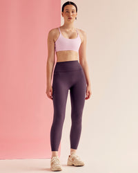 Woman wearing Elixir Ultra High-Rise 7/8 Legging Pockets - Midnight Plum | Model:Paradise | Size:S