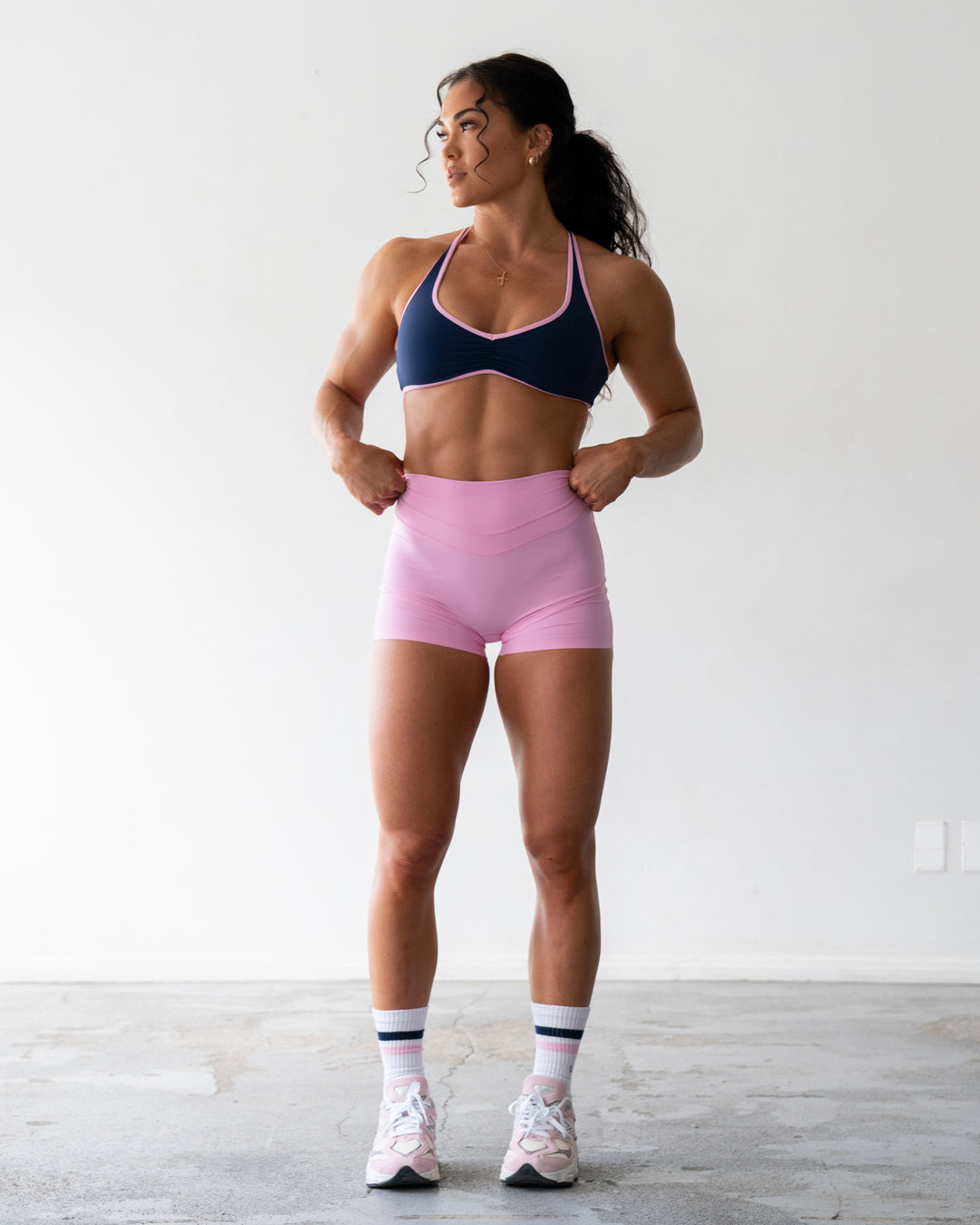 Woman wearing Enhance Ultra High-Rise 4&quot; Short - Pink Frosting | Model:Emily | Size:S