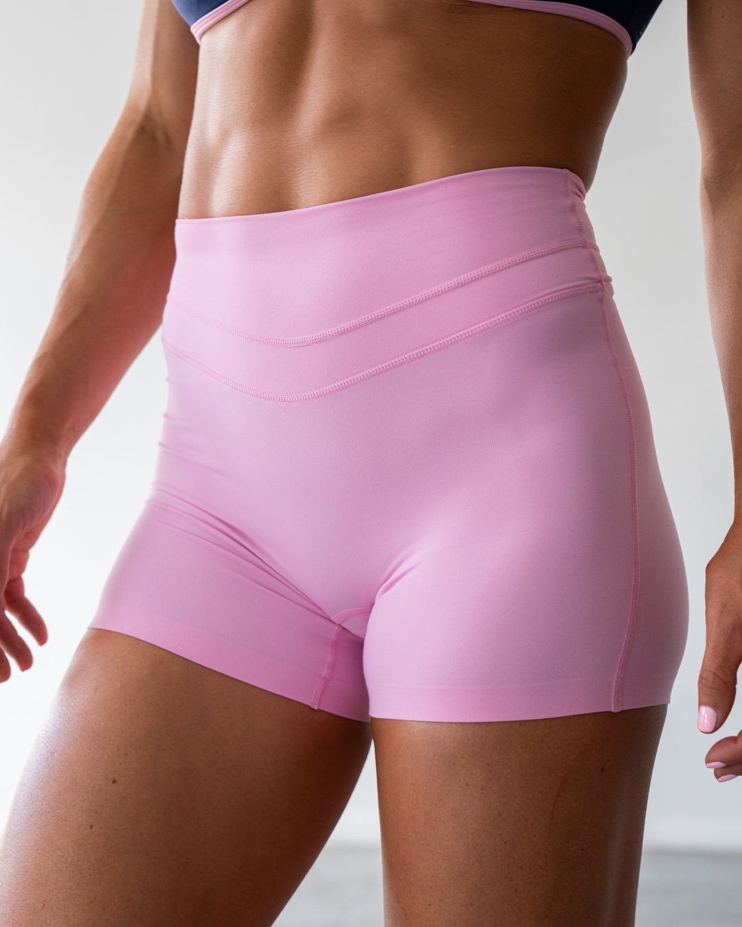 Woman wearing Enhance Ultra High-Rise 4&quot; Short - Pink Frosting | Model:Emily | Size:S