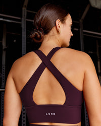 Woman wearing Evoke Longline Sports Bra - Cherry Lacquer | Model:Keisha | Size:S