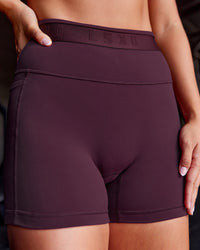Woman wearing Fusion Jacquard High-Rise 4” Short Pockets - Cherry Lacquer | Model:Iris | Size:S