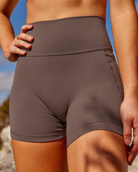 Woman wearing Fusion Ultra High-Rise 4" Short Pockets - Peppercorn | Set:true | Angle:closeup | Model:Rica | Size:S