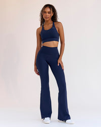 Woman wearing Fusion V-Contour High-Rise Flared Legging Pockets - Future Navy | Model:Jordan | Size:S