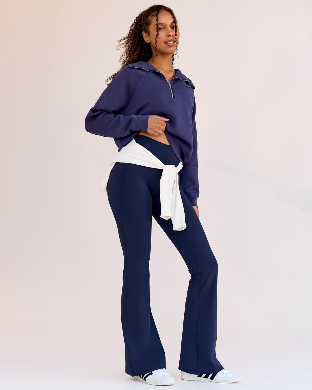 Woman wearing Fusion V-Contour High-Rise Flared Legging Pockets - Future Navy | Model:Jordan | Size:S