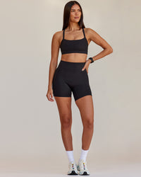 Woman wearing Fusion V-Contour Ultra High-Rise 6" Short Pockets - Black | Model:Rhiley | Size:S