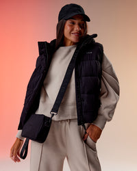 Woman wearing Go-To Puffer Vest - Black | Model:Kirstyn | Size:S