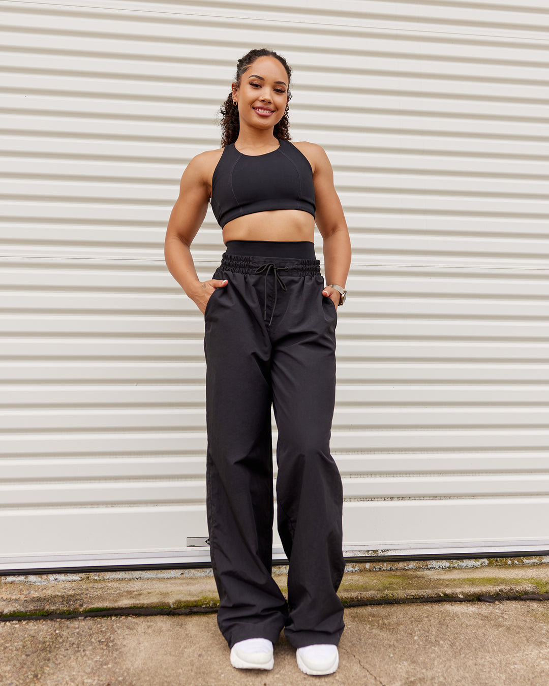 Woman wearing Ignite Parachute Pant - Black | Model:Tarnie | Size:S