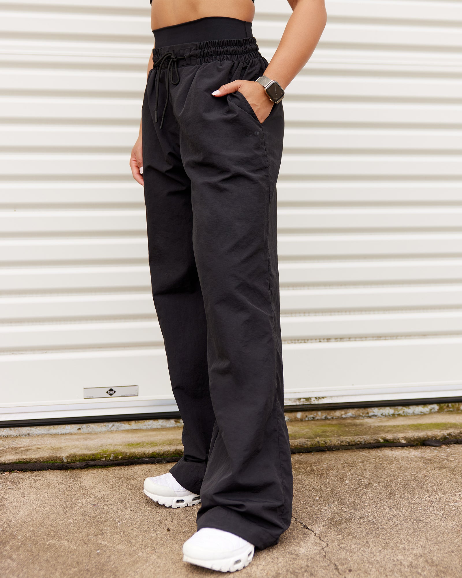 Woman wearing Ignite Parachute Pant - Black | Model:Tarnie | Size:S