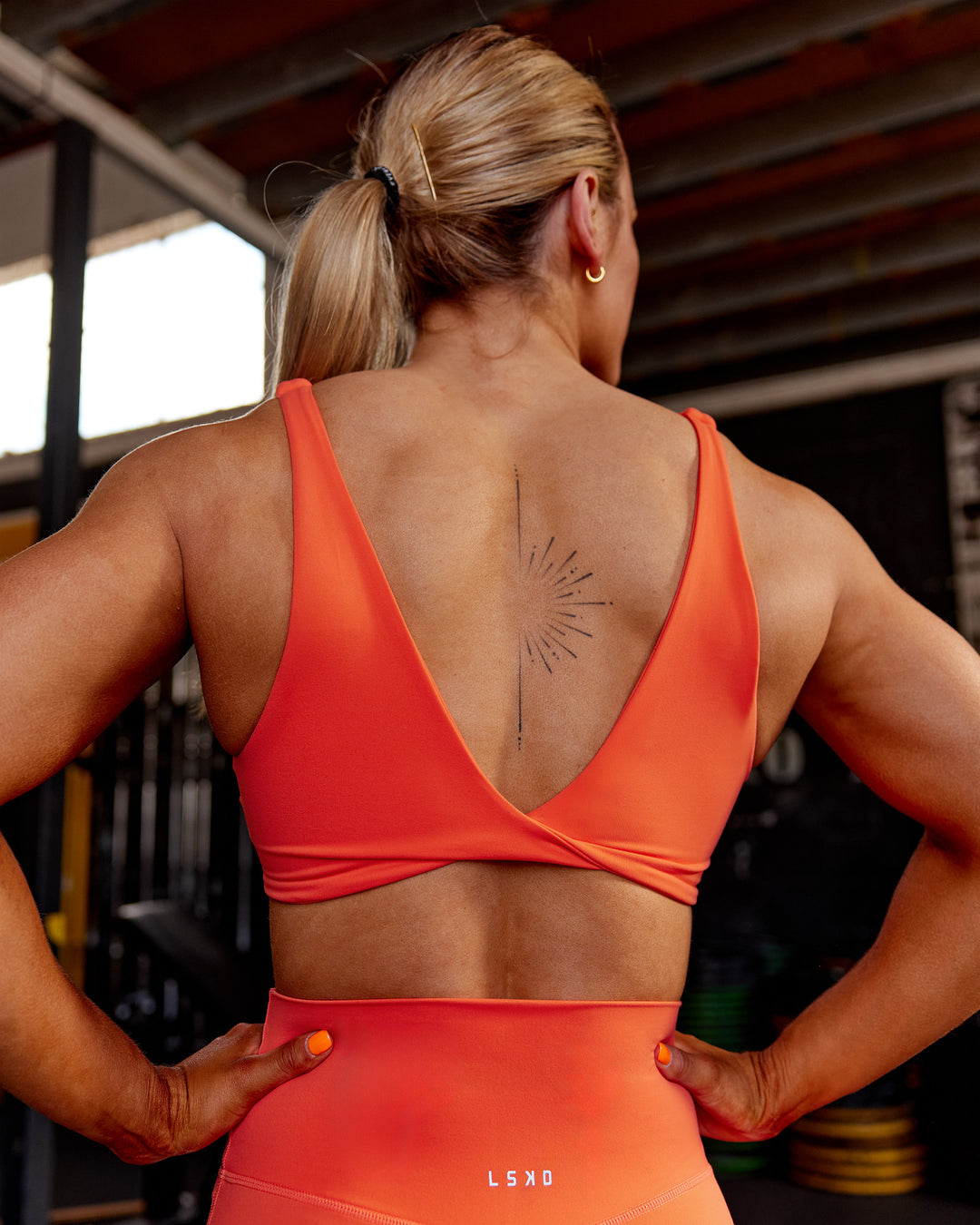 Woman wearing Impulse Reversible Sports Bra - Ultra Orange | Model:Georgia | Size:S