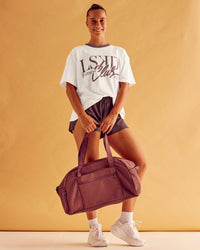 Woman wearing LSKD Fitness Club Heavyweight Oversized Tee - Off White-Cocoa Powder | Model:Charlize | Size:S