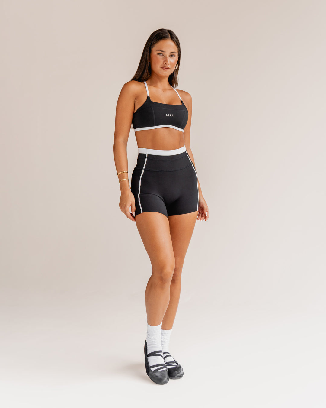 Woman wearing Liberate Contrast High-Rise 4" Short Pockets - Black-White | Model:Bianca | Size:S - view 1
