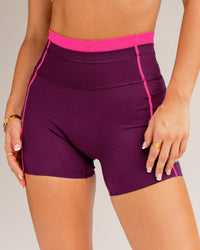 Woman wearing Liberate Contrast High-Rise 4" Short Pockets - Plum Caspia-Ultra Pink | Model:Jordi | Size:S