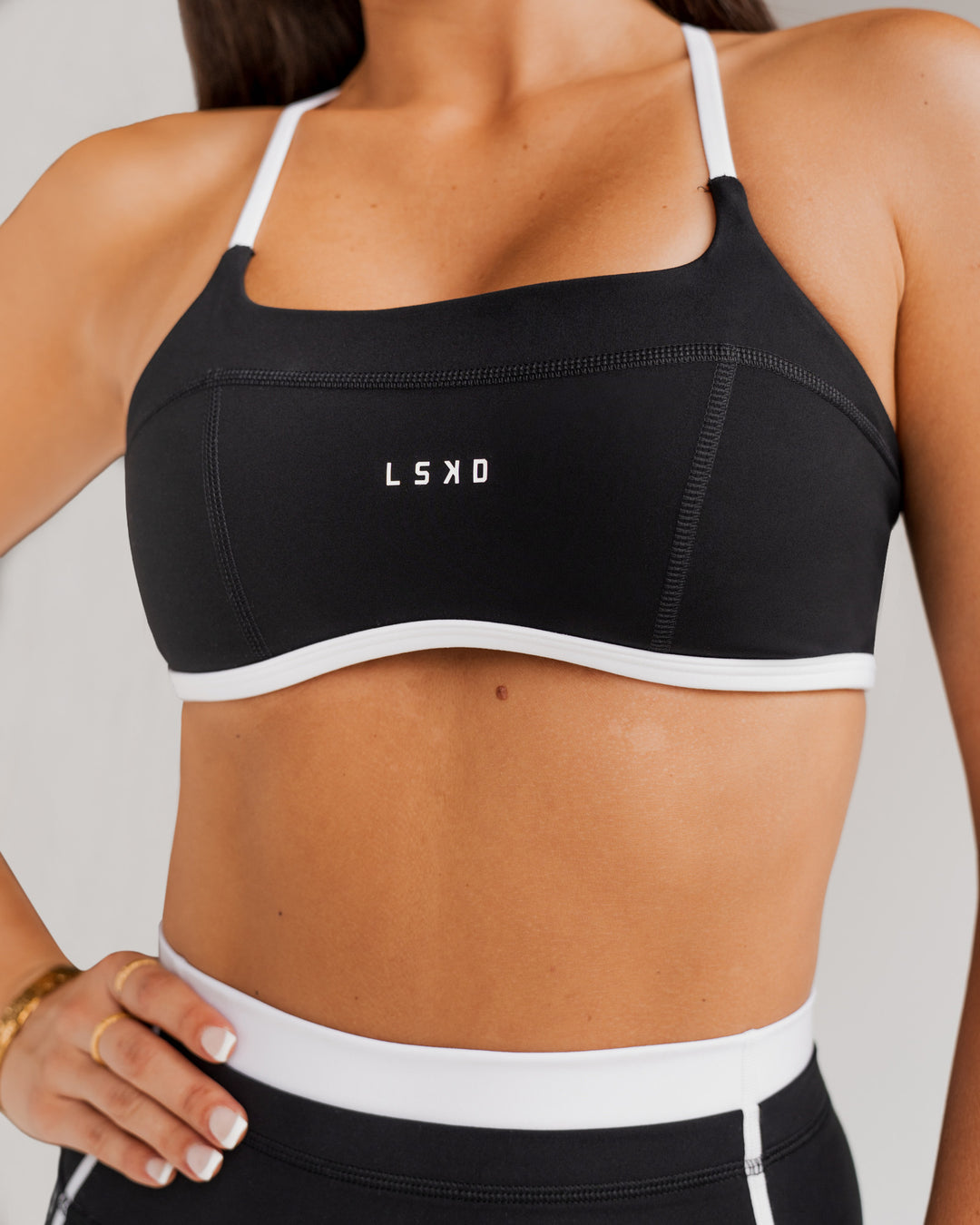 Woman wearing Liberate Sports Bra - Black-White | Model:Jordi | Size:S