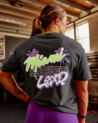 Woman wearing Miami Snatch FLXCotton Oversized Tee - Dark Storm-Marshmallow | Model:Gracie | Size:S