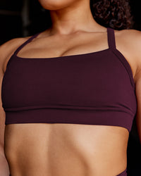 Woman wearing Momentum Sports Bra - Cherry Lacquer | Model:Tarnie | Size:S