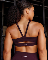 Woman wearing Momentum Sports Bra - Cherry Lacquer | Model:Tarnie | Size:S