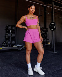 Woman wearing Momentum Sports Bra - Ultra Fuchsia | Model:Beccie | Size:S