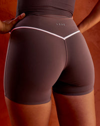 Woman wearing Pinnacle High-Rise 4" Short - Cocoa Powder-Off White | Model:Shae | Size:S