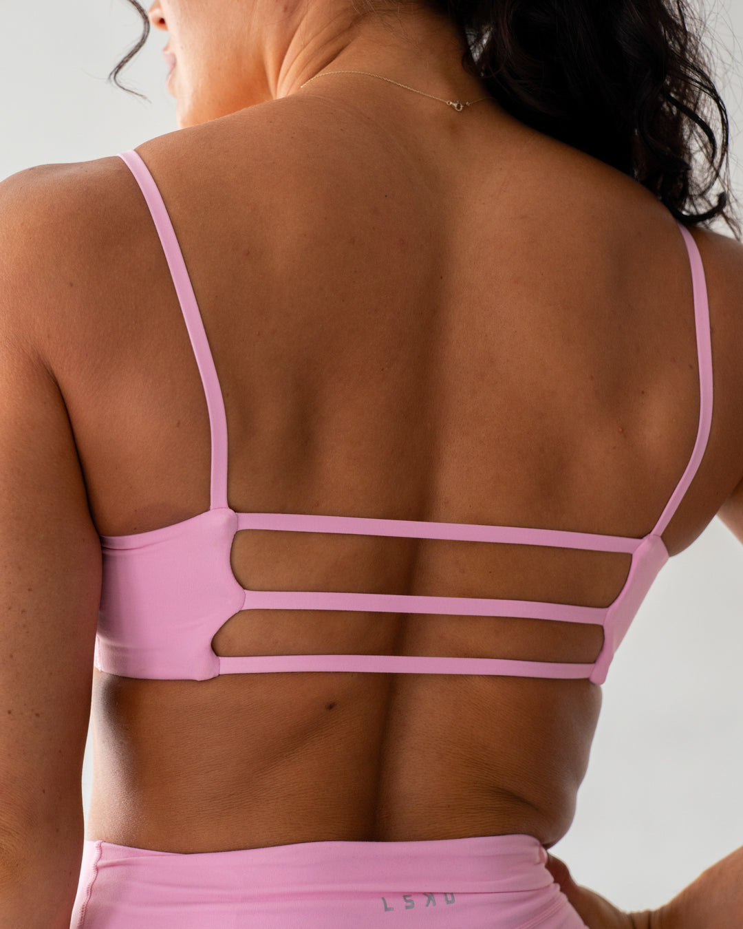 Woman wearing Rebel Heart Sports Bra - Pink Frosting | Model:Emily | Size:S