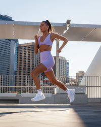 Woman wearing Reform Sports Bra - Violet Ray | Size:S