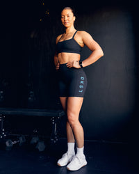Woman wearing Rep Ultra High-Rise 6" Short Pockets - Black-Blue Atoll | Model:Bailey | Size:S