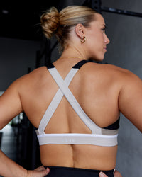 Woman wearing Revitalise Sports Bra - Black-Multi | Model:Shae | Size:S