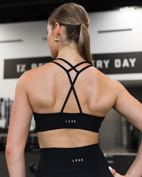 Woman wearing Stamina Pulse Sports Bra - Black | Model:Sarah | Size:S