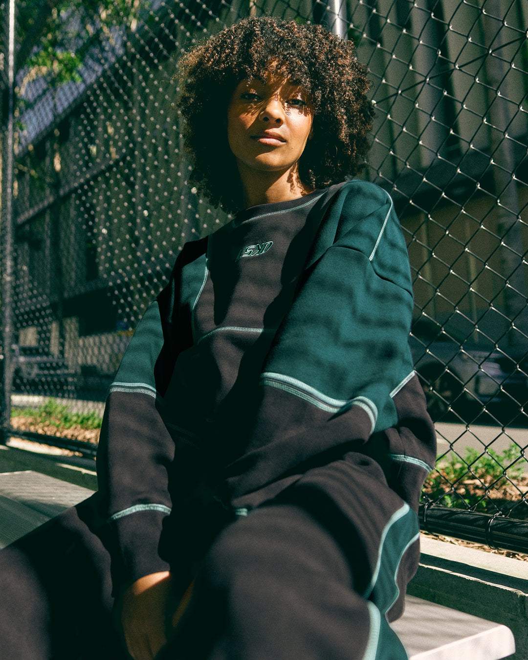 Woman wearing Stitch Up Oversized Fleece Sweater - Black-Dark Moss | Model:Tomi | Size:S