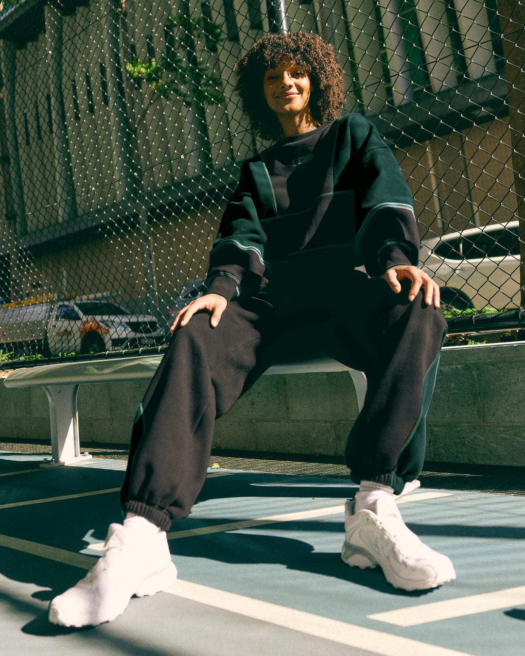 Woman wearing Stitch Up Oversized Fleece Sweater - Black-Dark Moss | Model:Tomi | Size:S